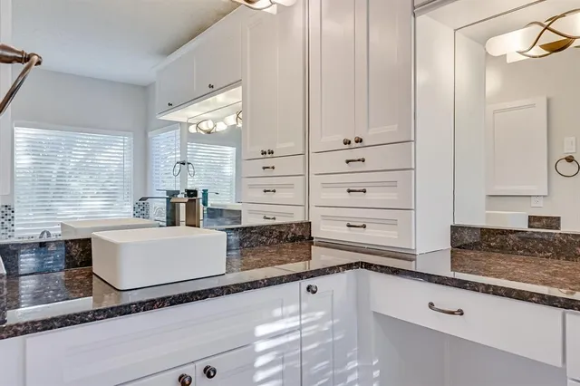 a kitchen with granite countertop a sink and a stove