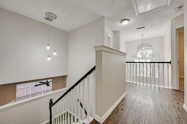 a view of a hallway with stairs