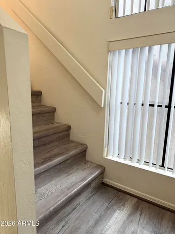 a bedroom with a large bed and a large window