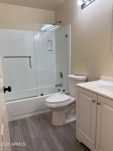 a living room with lots of furniture a fireplace and kitchen view