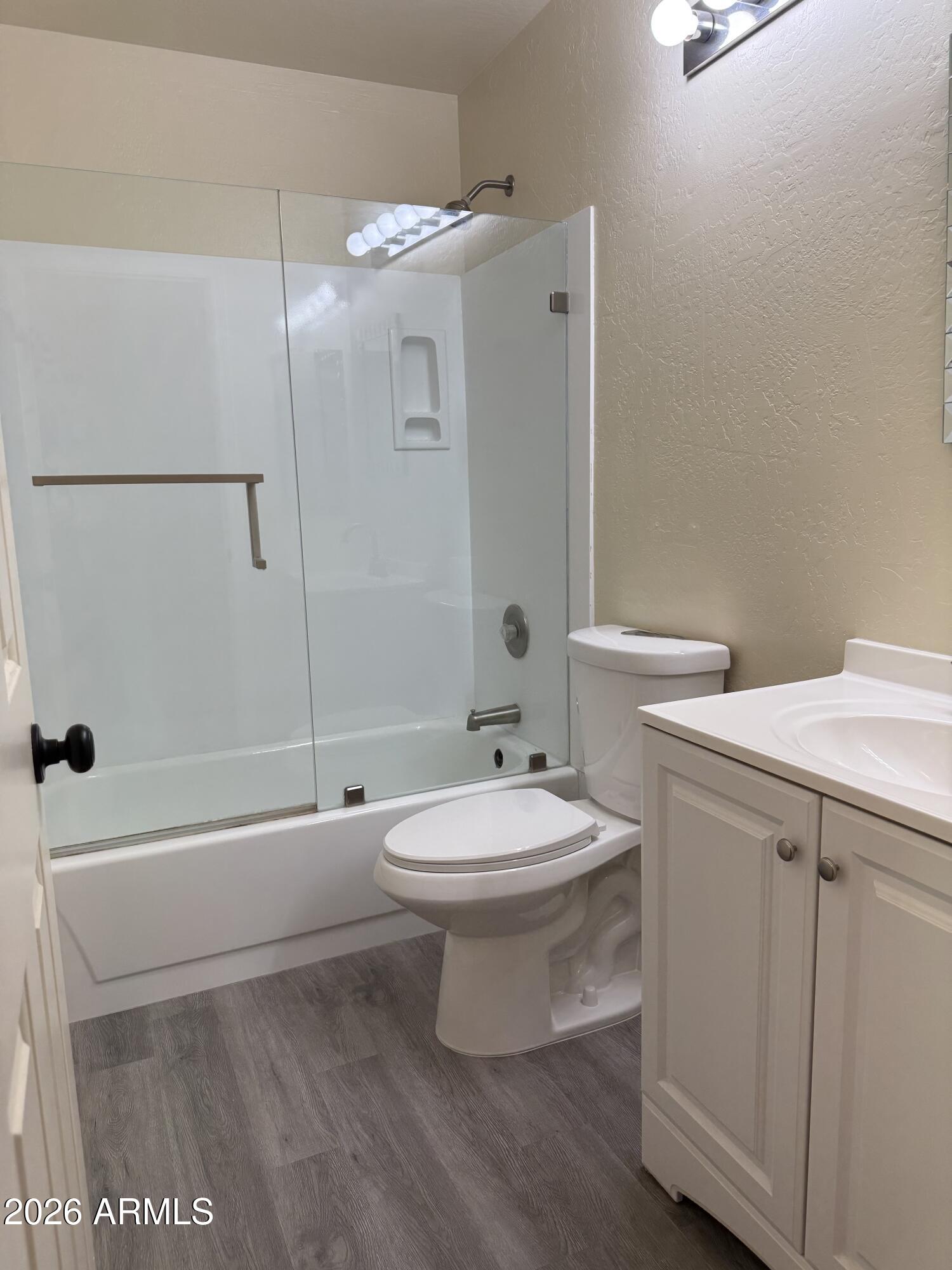9705 East Mountain View Road, Unit 1019 Scottsdale, AZ 85258 - Photo 28 of 32 a bathroom with a toilet a sink and bathtub