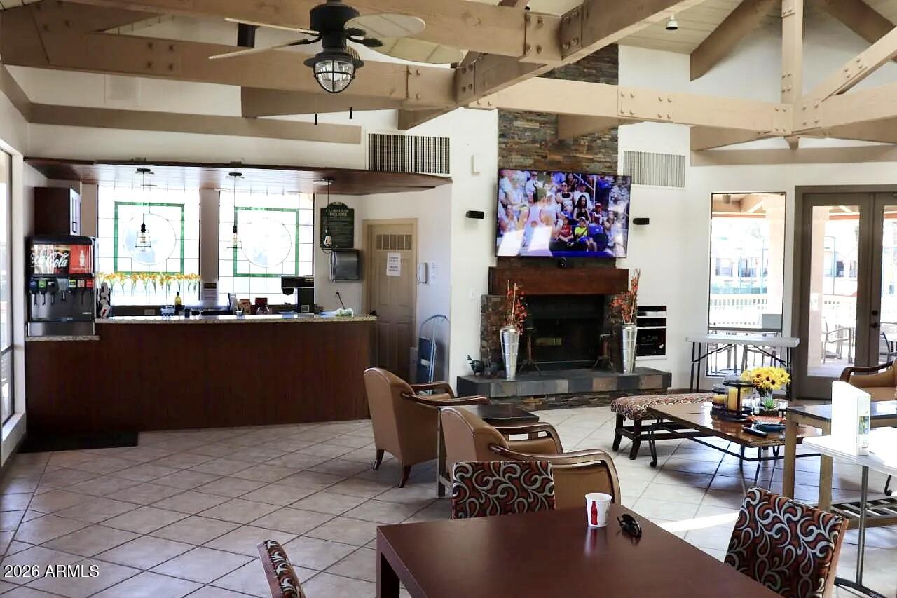 9705 East Mountain View Road, Unit 1019 Scottsdale, AZ 85258 - Photo 30 of 32 a living room with lots of furniture a fireplace and kitchen view