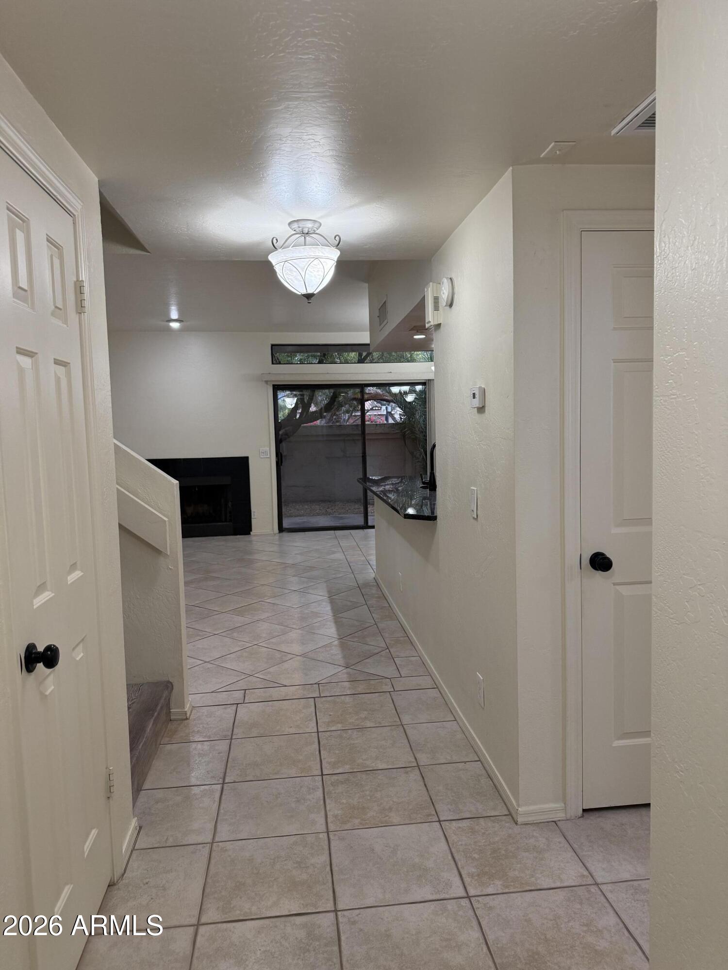 9705 East Mountain View Road, Unit 1019 Scottsdale, AZ 85258 - Photo 3 of 32 a view of a hallway with a kitchen