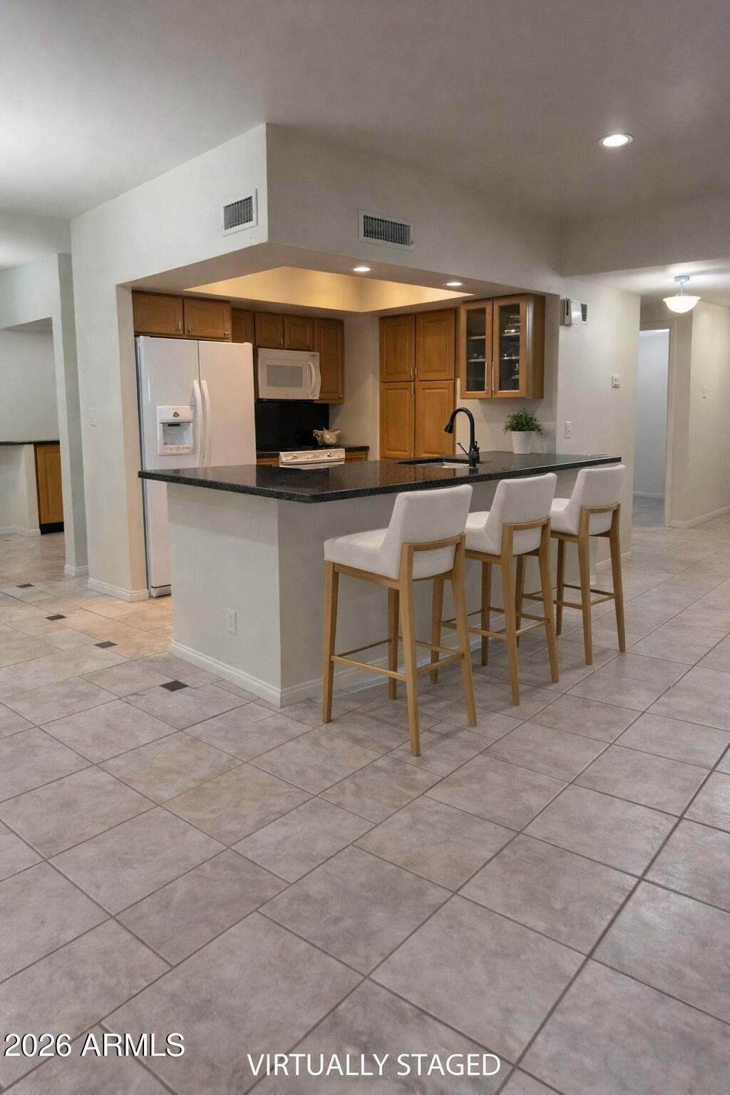 9705 East Mountain View Road, Unit 1019 Scottsdale, AZ 85258 - Photo 6 of 32 a living room with stainless steel appliances kitchen island granite countertop a sink and cabinets