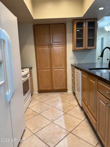 a white toilet sitting next to a white sink