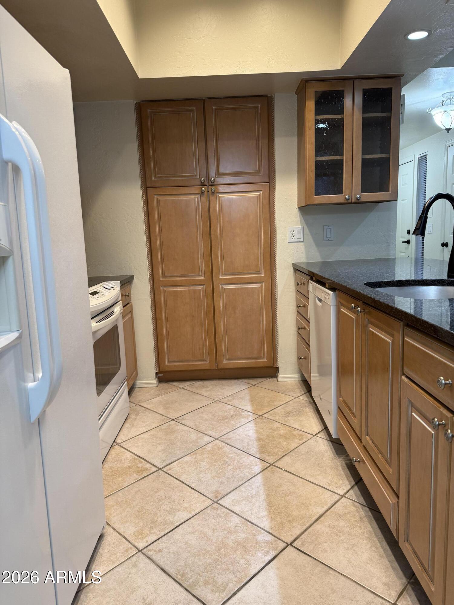 9705 East Mountain View Road, Unit 1019 Scottsdale, AZ 85258 - Photo 9 of 32 a kitchen with a sink a microwave and cabinets