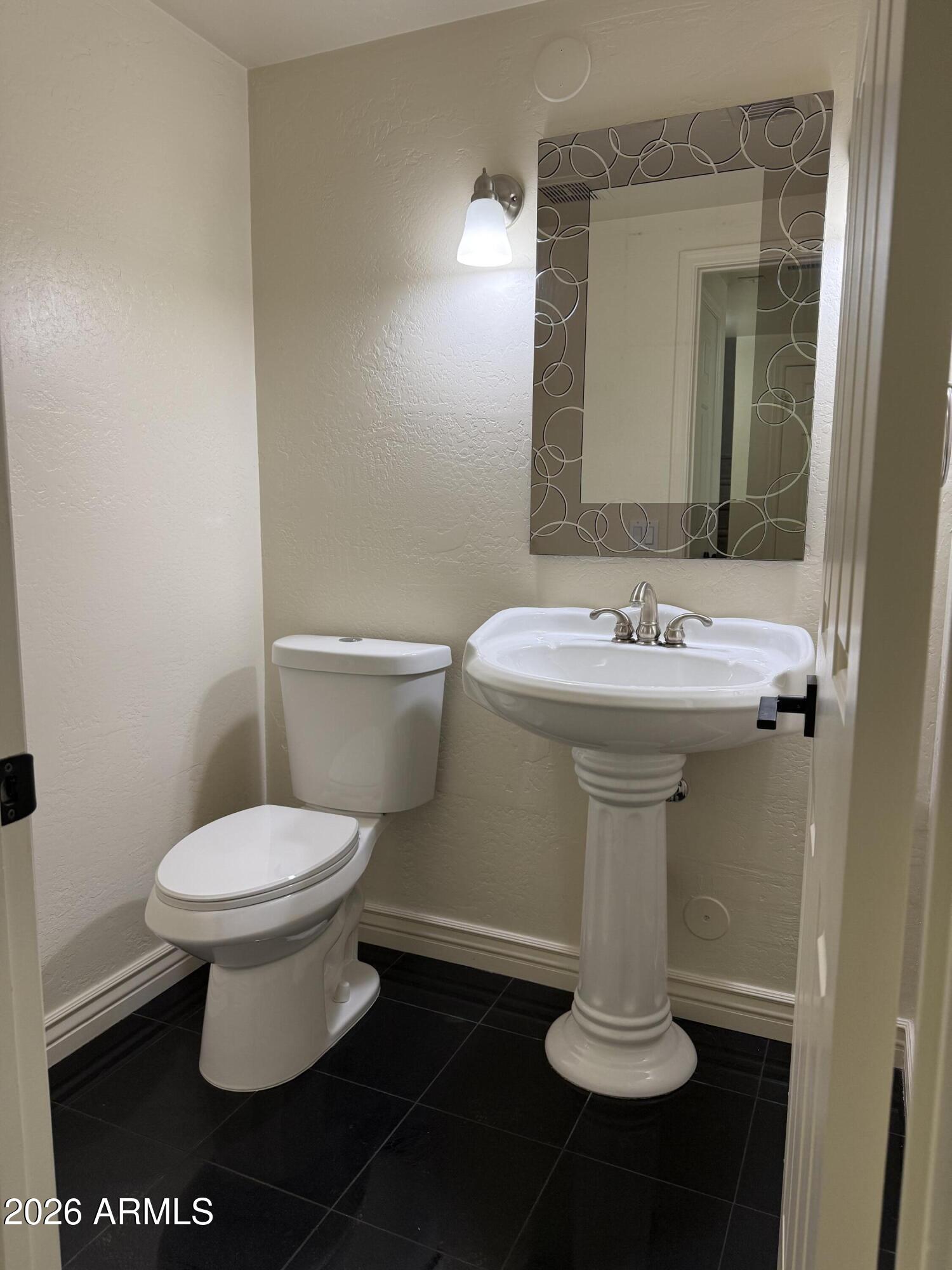 9705 East Mountain View Road, Unit 1019 Scottsdale, AZ 85258 - Photo 10 of 32 a white toilet sitting next to a white sink