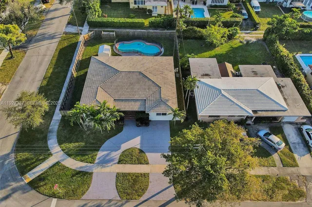 an aerial view of a house with a yard basket ball court and outdoor seating