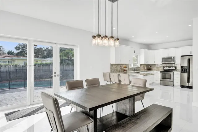 a kitchen with stainless steel appliances granite countertop a stove a sink and a refrigerator