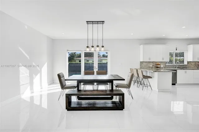 an aerial view of a house with swimming pool and a yard