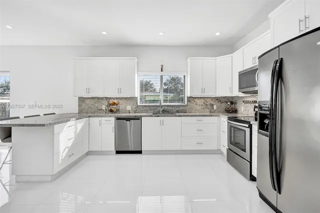 a view of a room with wooden floor and potted plant