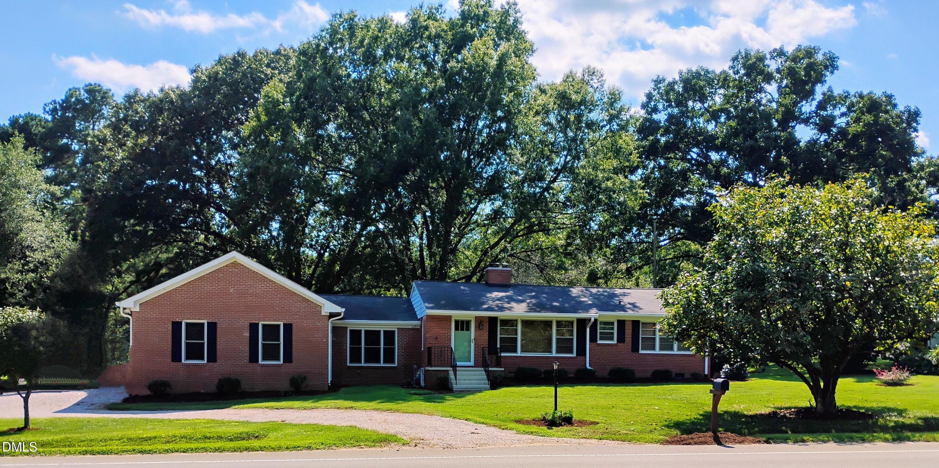 6121 Yates Mill Pond Road Raleigh, NC 27606 - Photo 1 of 18 a front view of a house with a yard