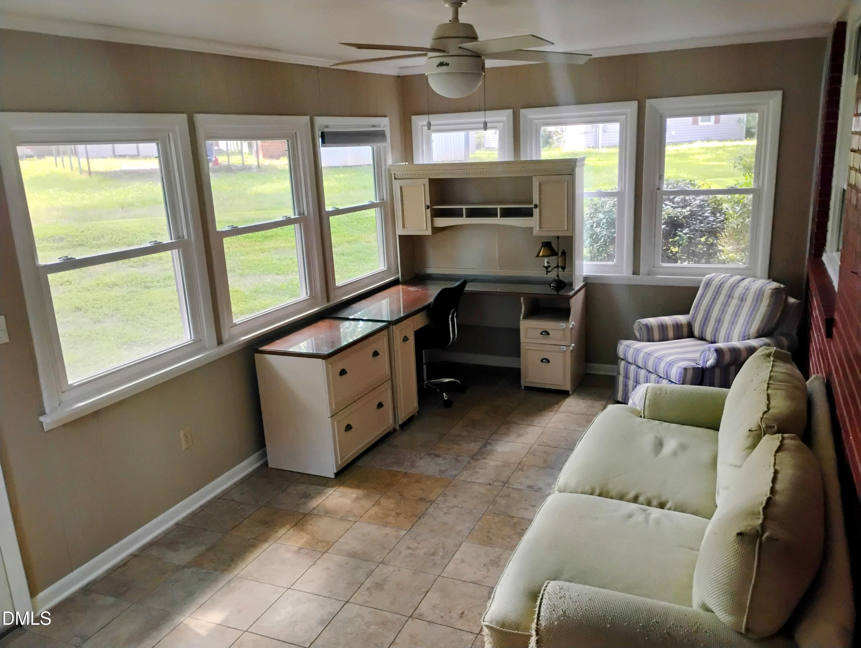 6121 Yates Mill Pond Road Raleigh, NC 27606 - Photo 11 of 18 a large white kitchen with cabinets a sink a window and stainless steel appliances