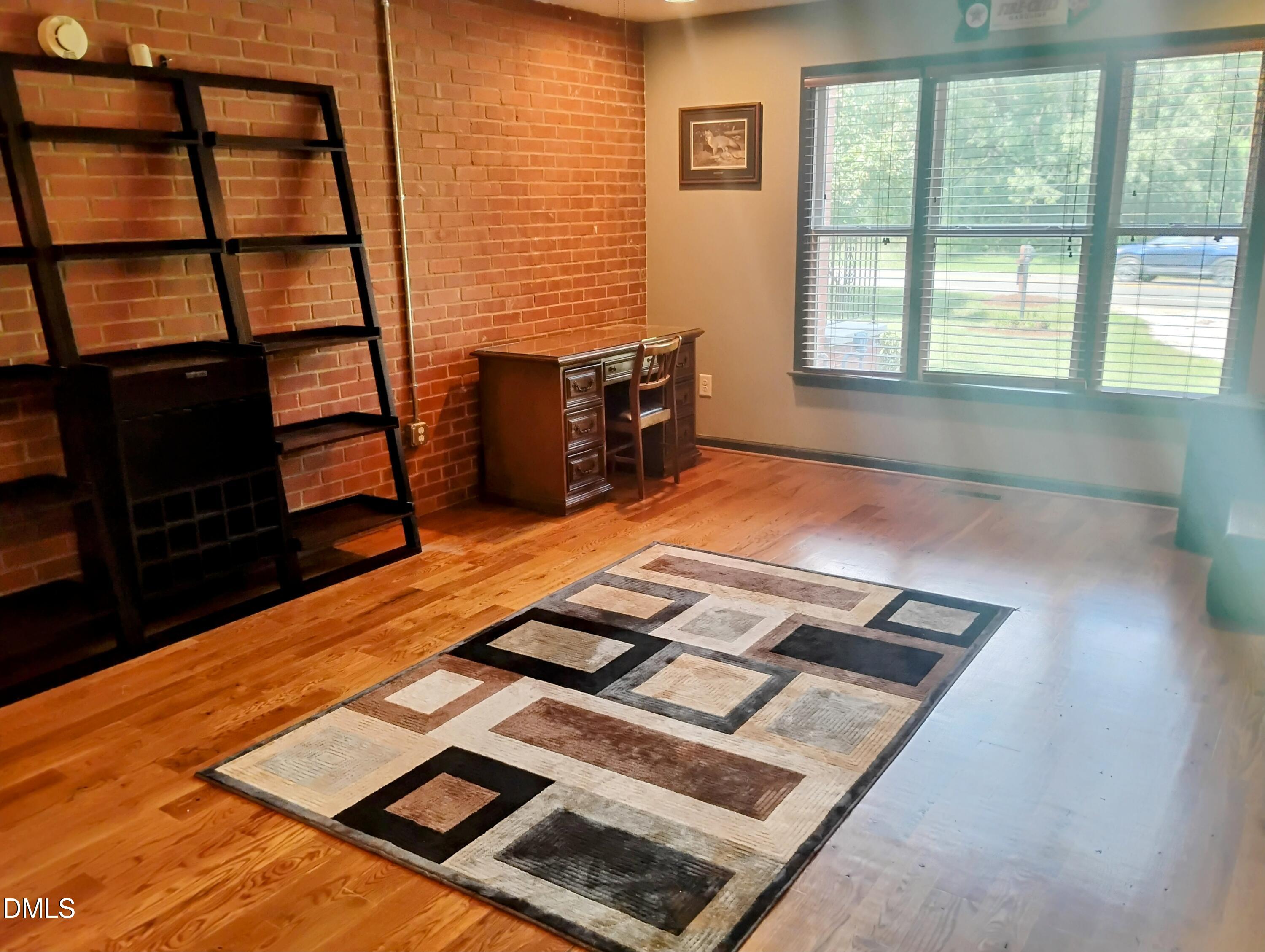 6121 Yates Mill Pond Road Raleigh, NC 27606 - Photo 12 of 18 a room with wooden floor and windows