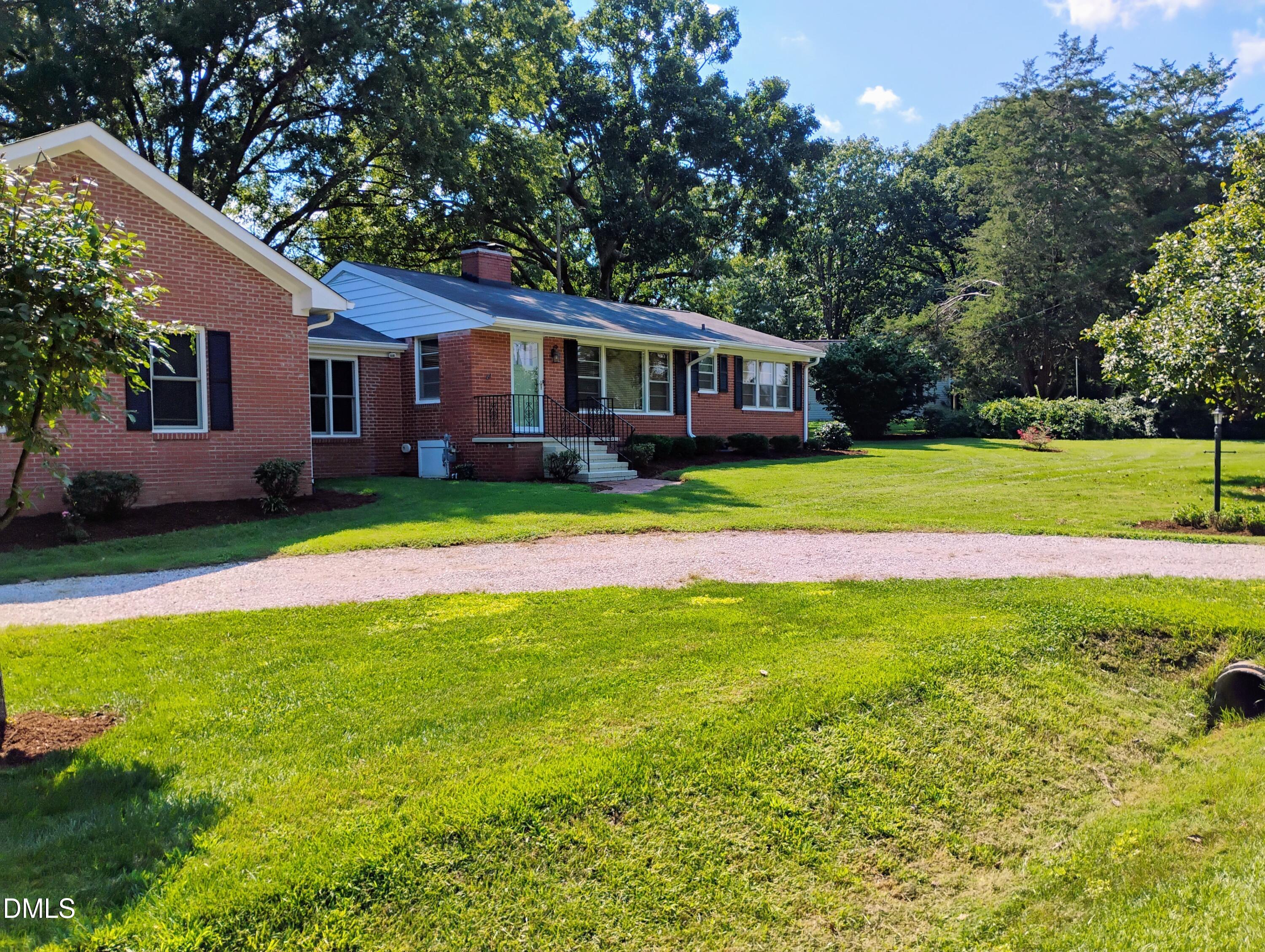 6121 Yates Mill Pond Road Raleigh, NC 27606 - Photo 17 of 18 a front view of house with yard and green space