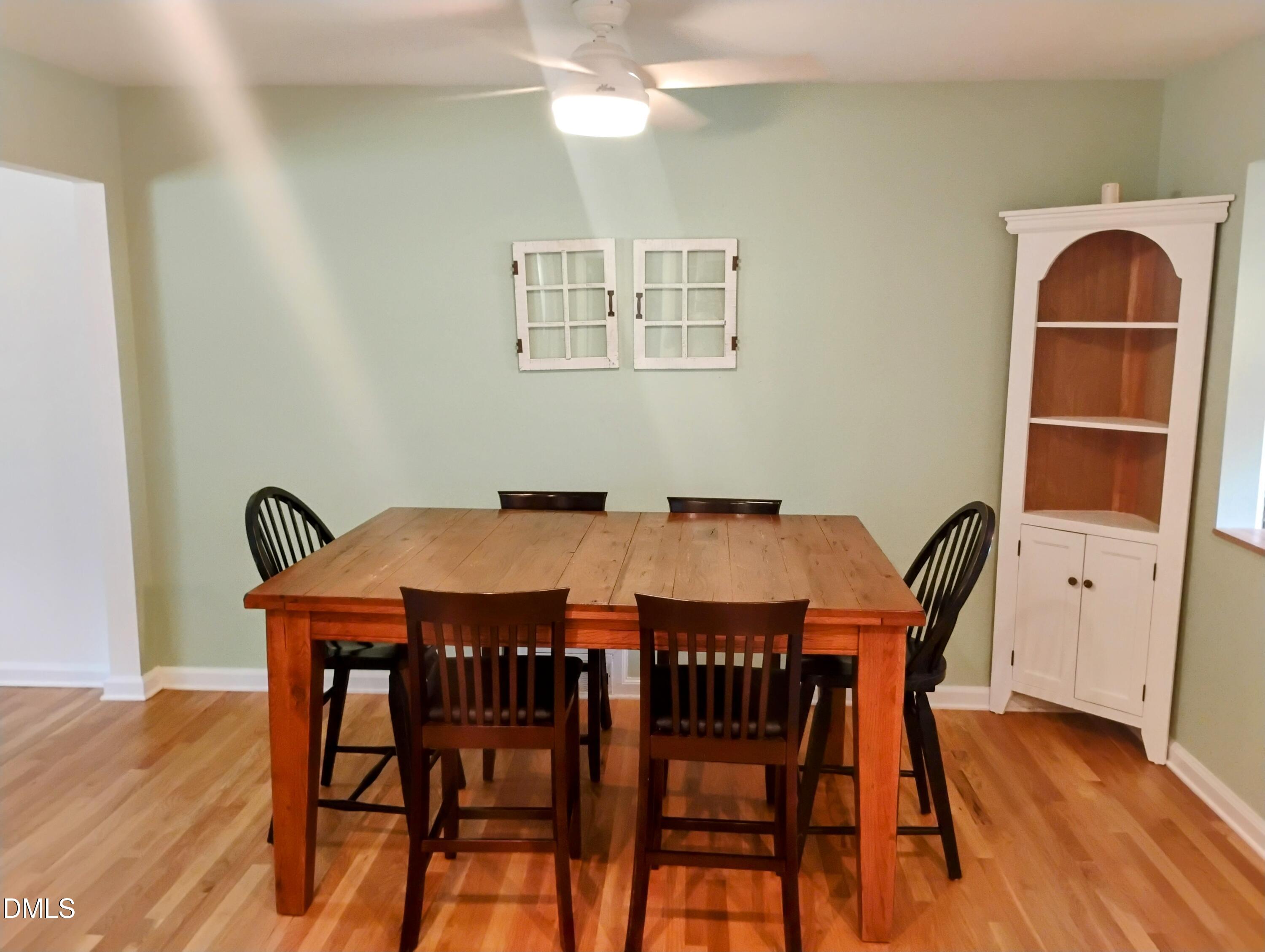 6121 Yates Mill Pond Road Raleigh, NC 27606 - Photo 4 of 18 a view of a dining room with furniture and wooden floor