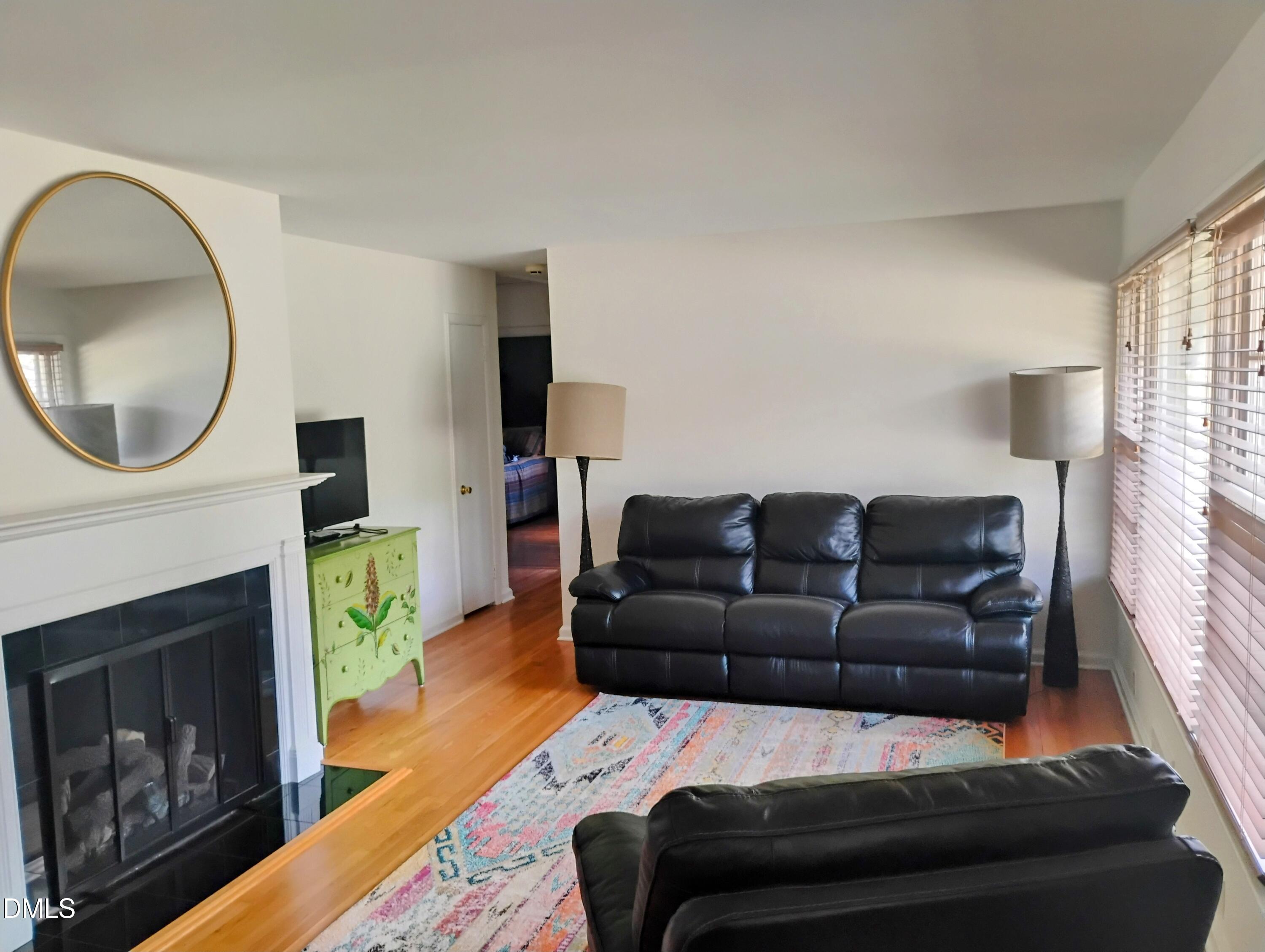 6121 Yates Mill Pond Road Raleigh, NC 27606 - Photo 5 of 18 a living room with furniture a fireplace and a large window
