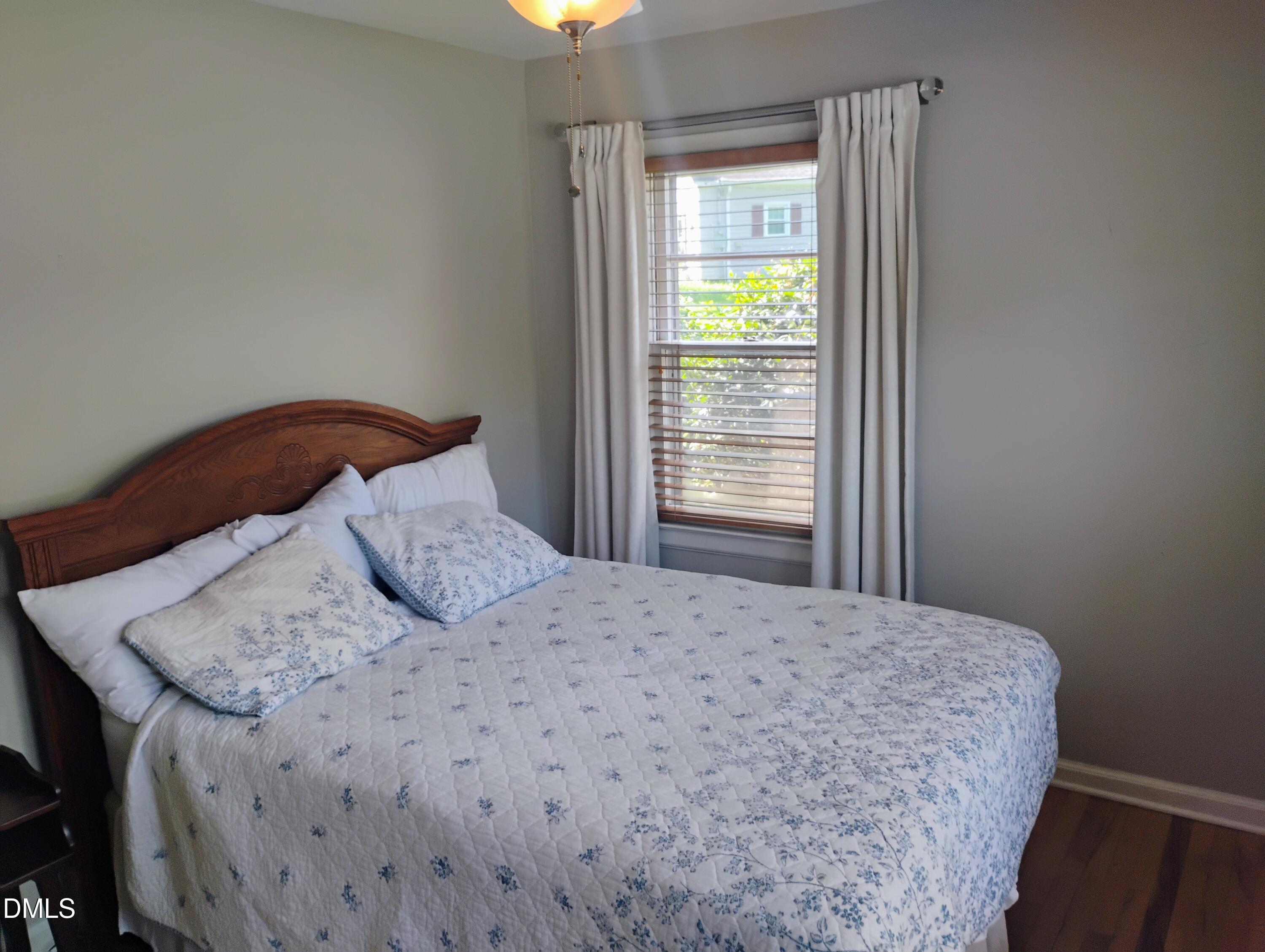 6121 Yates Mill Pond Road Raleigh, NC 27606 - Photo 8 of 18 a bedroom with a bed and a window