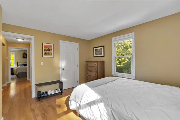 a bedroom with a bed and a chair