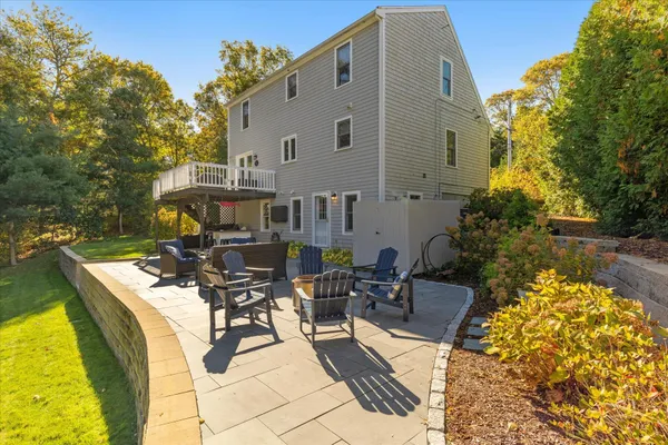 a view of a patio with table and chairs and couches