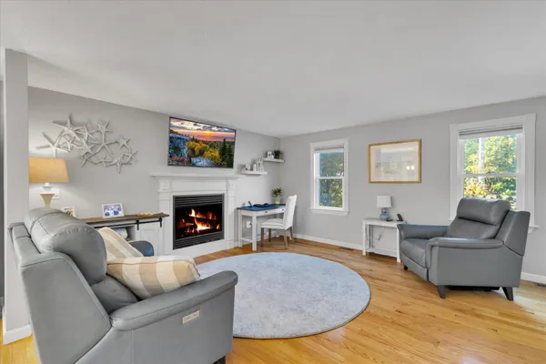 a kitchen with stainless steel appliances kitchen island granite countertop a table chairs sink and cabinets