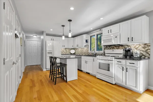 a kitchen with lots of counter top space and dining table chairs