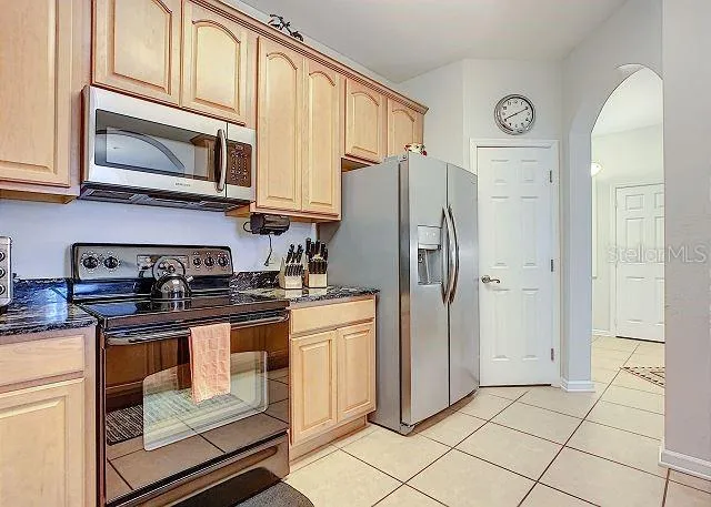 a kitchen with stainless steel appliances granite countertop a stove and a sink