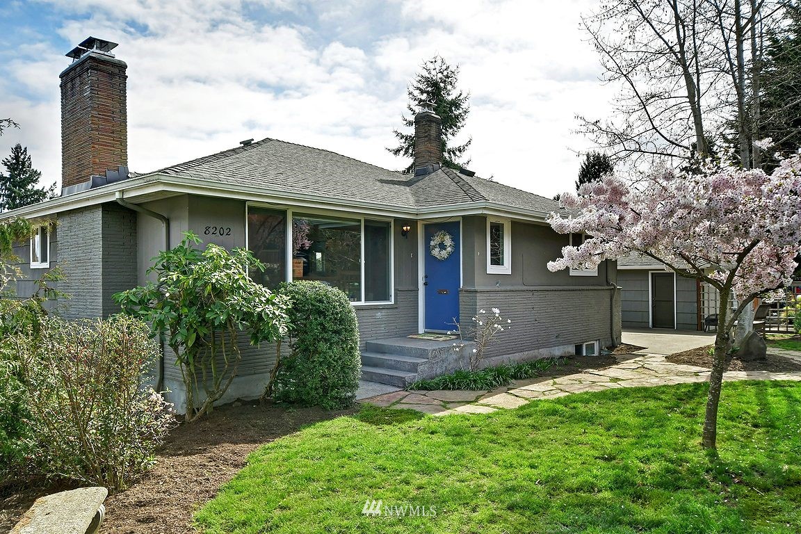 8202 37th Avenue Southwest Seattle, WA 98126 - Photo 1 of 27 a front view of a house with a garden and yard