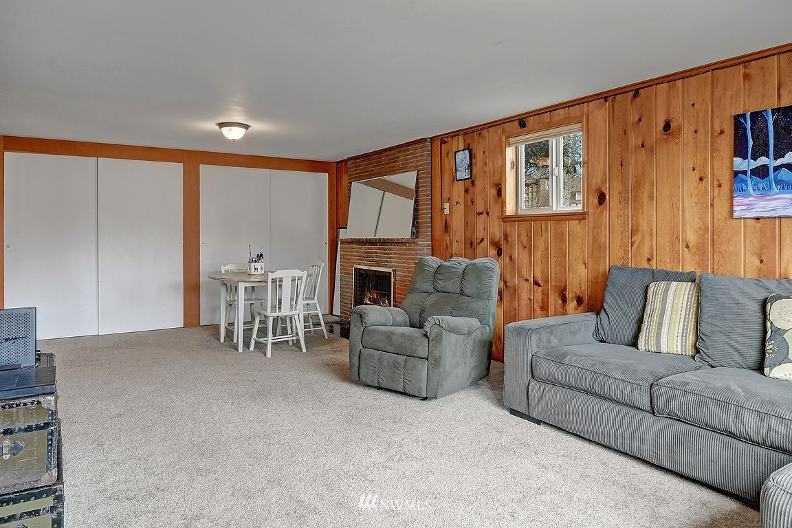 8202 37th Avenue Southwest Seattle, WA 98126 - Photo 15 of 27 a living room with furniture a fireplace and a flat screen tv