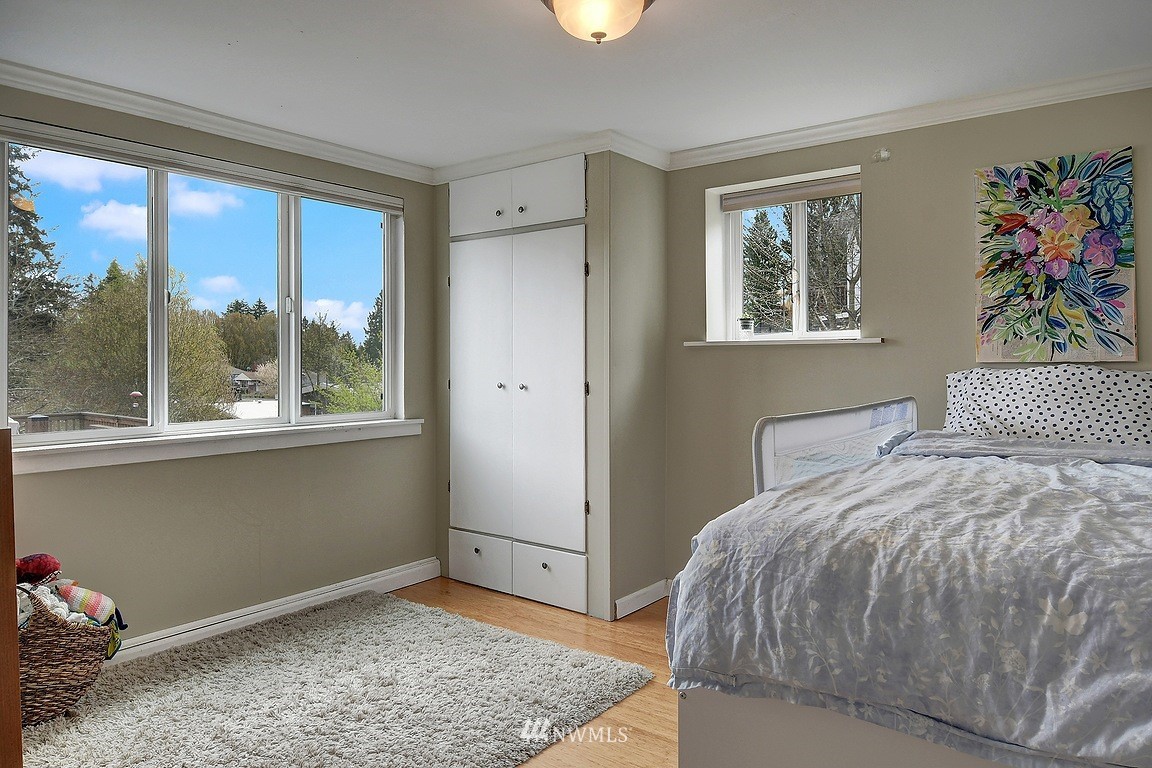 8202 37th Avenue Southwest Seattle, WA 98126 - Photo 17 of 27 a bedroom with a bed and a window