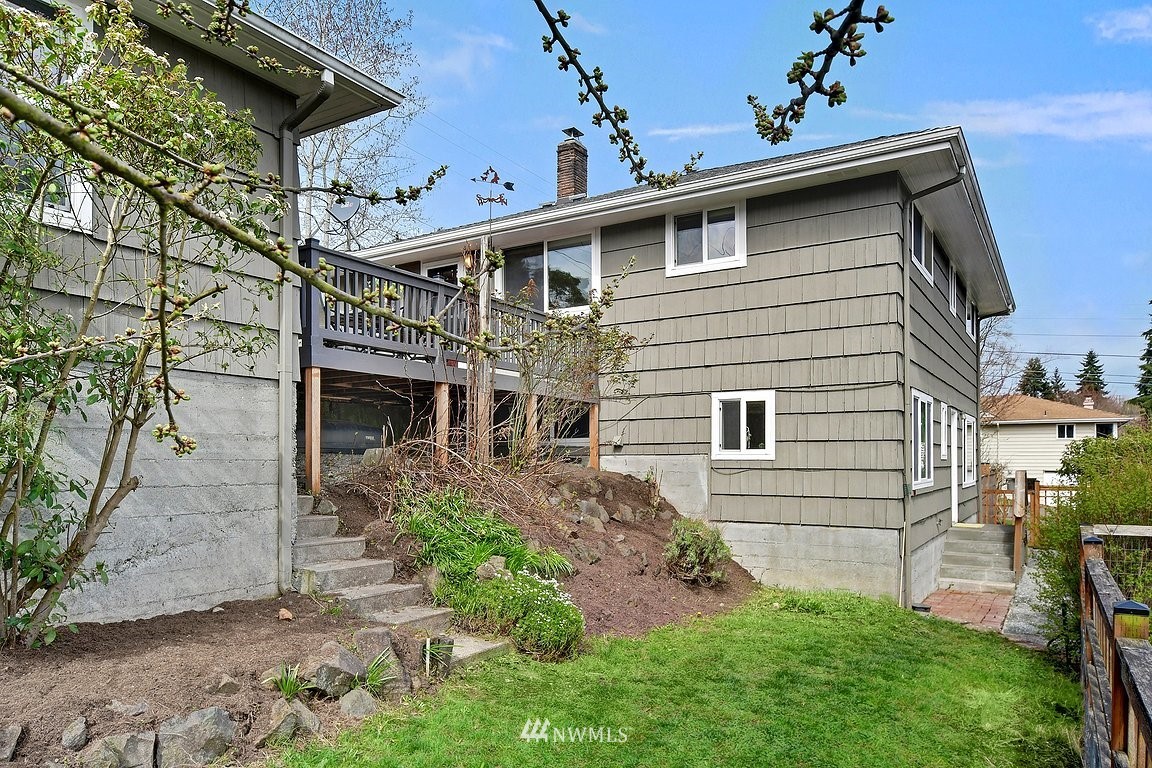 8202 37th Avenue Southwest Seattle, WA 98126 - Photo 21 of 27 a front view of a house with a yard