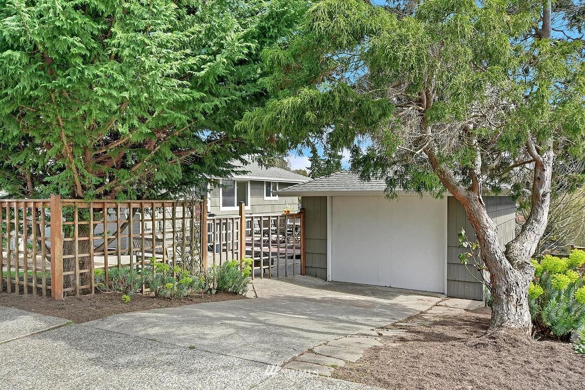 8202 37th Avenue Southwest Seattle, WA 98126 - Photo 22 of 27 a front view of a house with a garden