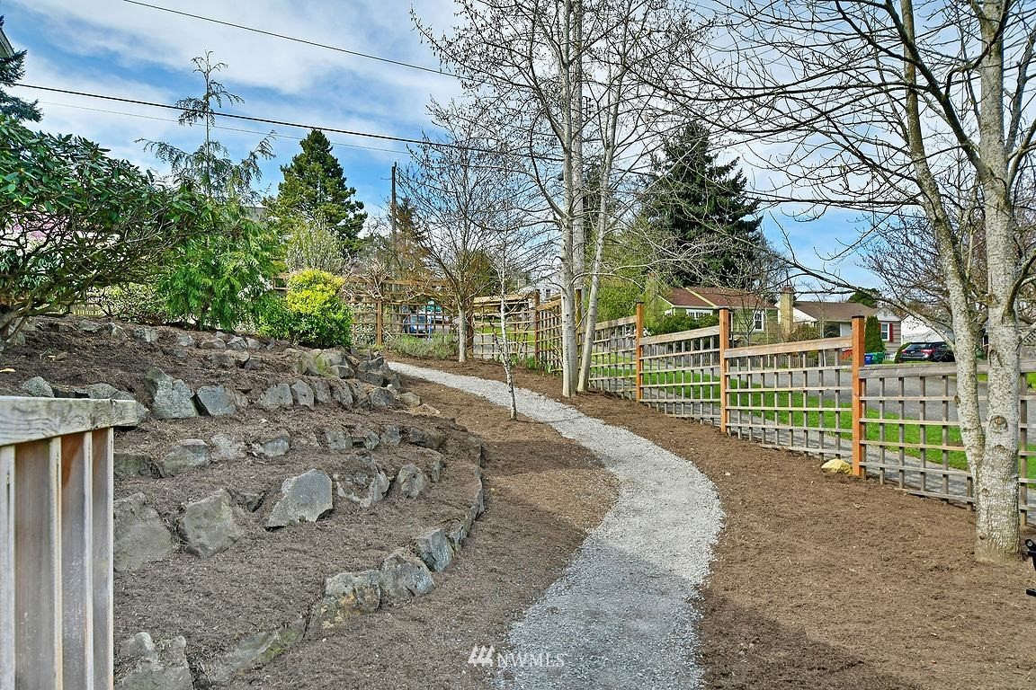 8202 37th Avenue Southwest Seattle, WA 98126 - Photo 26 of 27 a view of a yard with a house and a trees