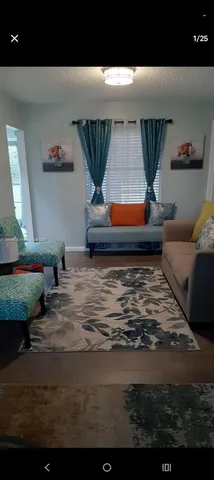 a living room with furniture and window