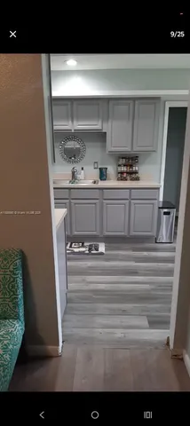 a kitchen with a sink a stove and cabinets