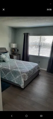a bedroom with a bed and large window