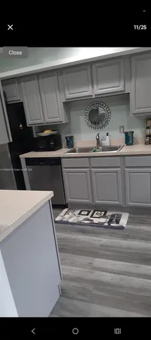 a kitchen with a stove and white cabinets