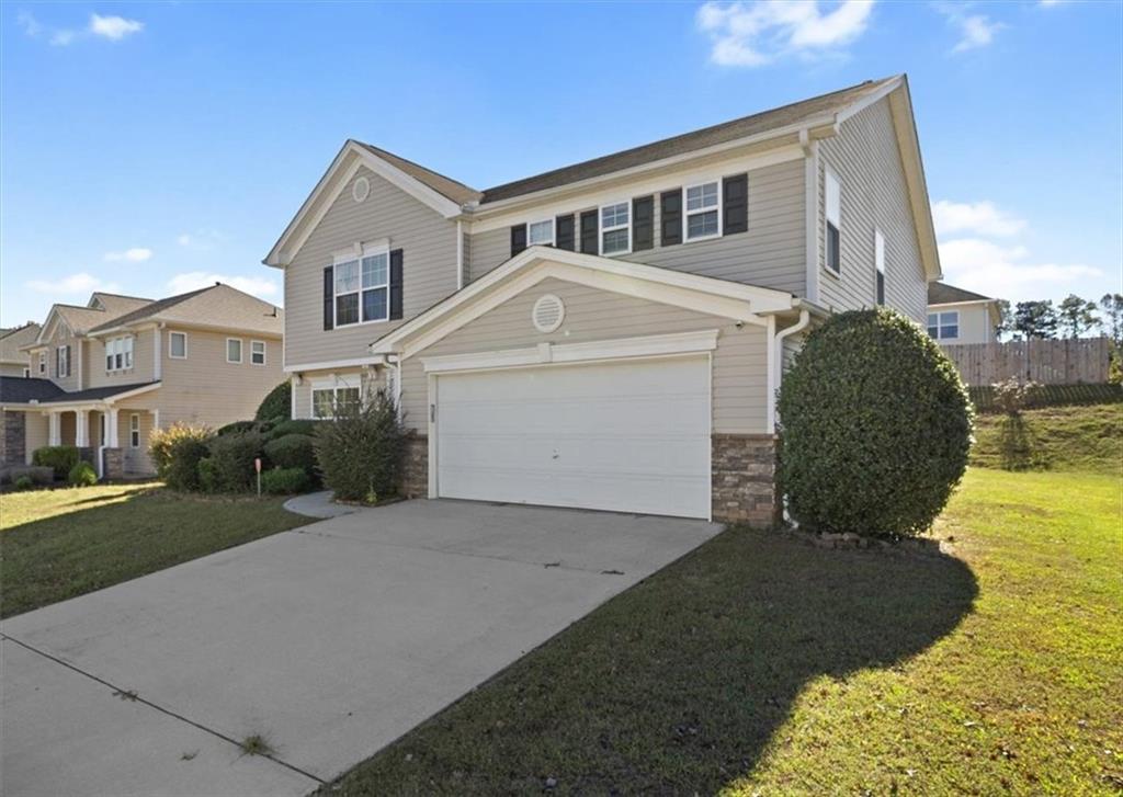 a front view of a house with a yard and garage
