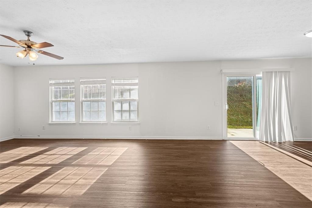 2068 White Top Road Southeast Lawrenceville, GA 30045 - Photo 11 of 41 a view of an empty room with a window and wooden floor