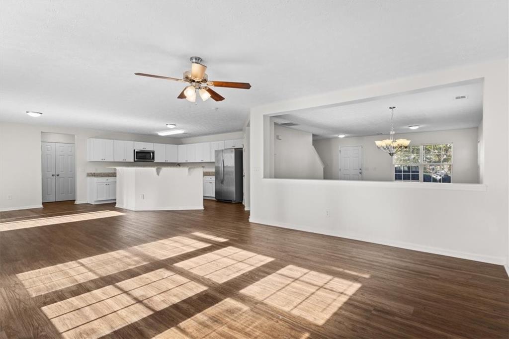 2068 White Top Road Southeast Lawrenceville, GA 30045 - Photo 13 of 41 a view of a big room with wooden floor and a kitchen