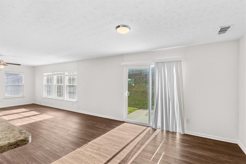 2068 White Top Road Southeast Lawrenceville, GA 30045 - Photo 19 of 41 an empty room with wooden floor and windows