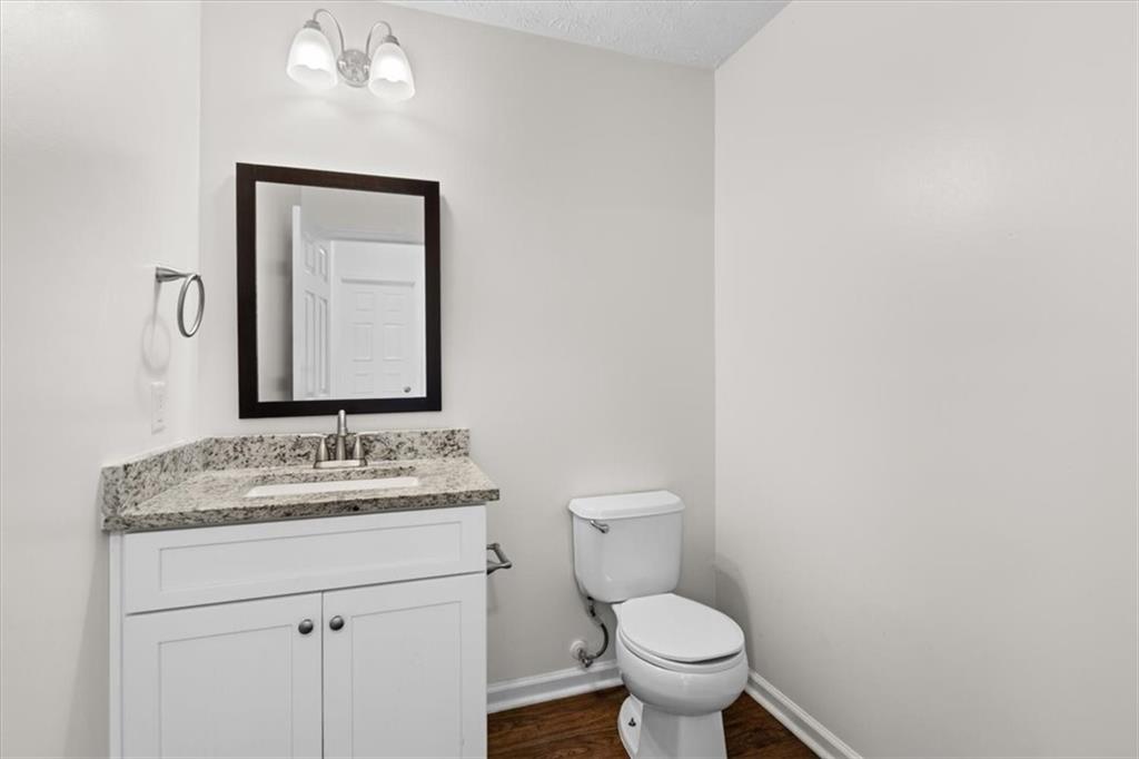 2068 White Top Road Southeast Lawrenceville, GA 30045 - Photo 20 of 41 a bathroom with a granite countertop toilet sink and mirror