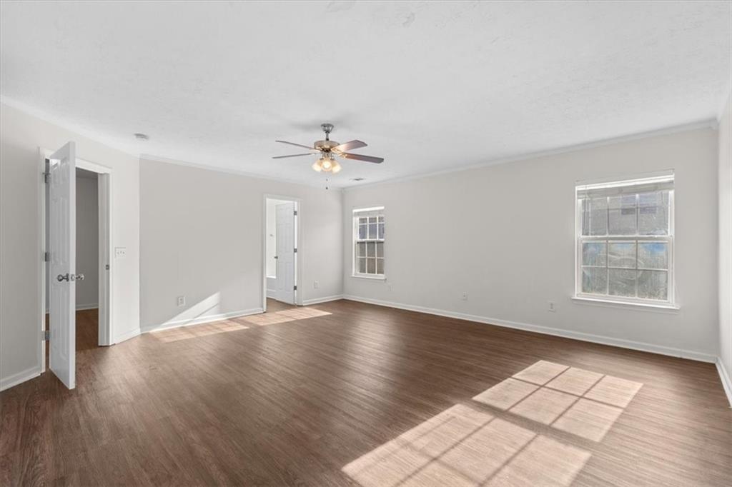 2068 White Top Road Southeast Lawrenceville, GA 30045 - Photo 22 of 41 a view of an empty room with wooden floor and a window