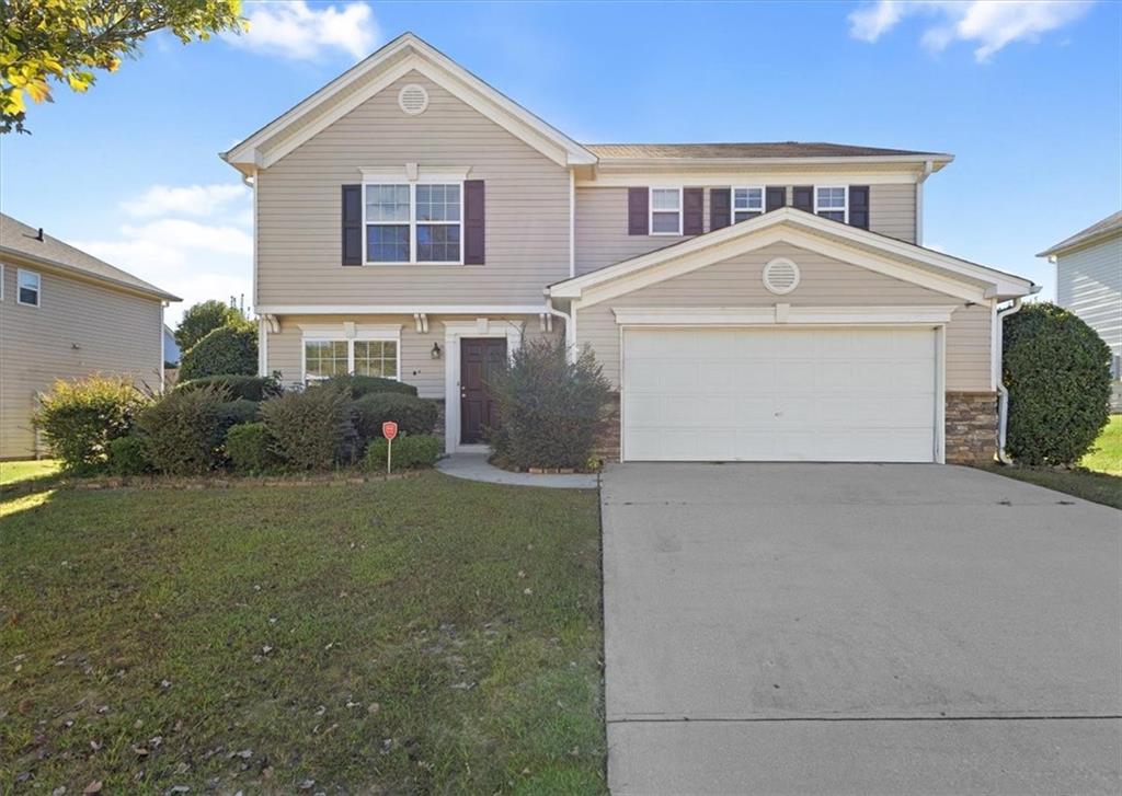 2068 White Top Road Southeast Lawrenceville, GA 30045 - Photo 3 of 41 a front view of a house with garden