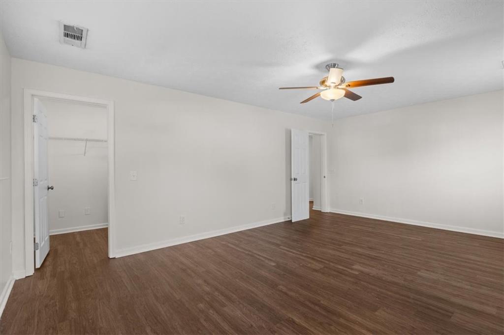 2068 White Top Road Southeast Lawrenceville, GA 30045 - Photo 31 of 41 a view of a room with wooden floor and a ceiling fan