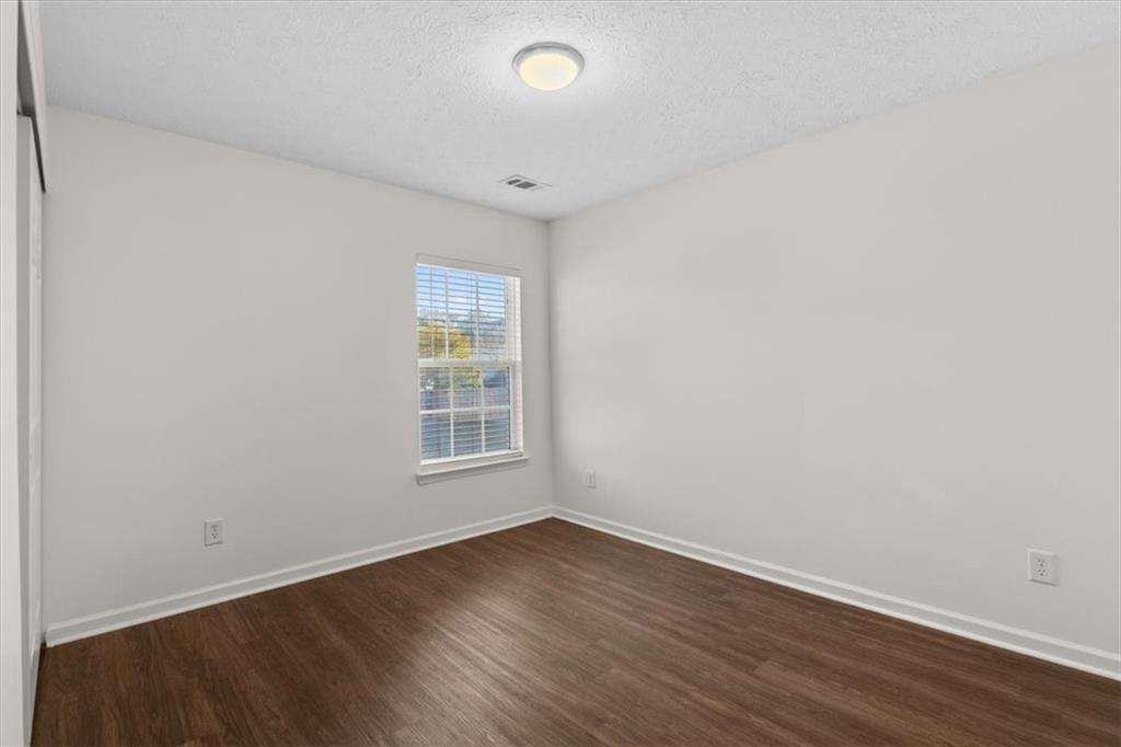 2068 White Top Road Southeast Lawrenceville, GA 30045 - Photo 33 of 41 an empty room with wooden floor and windows