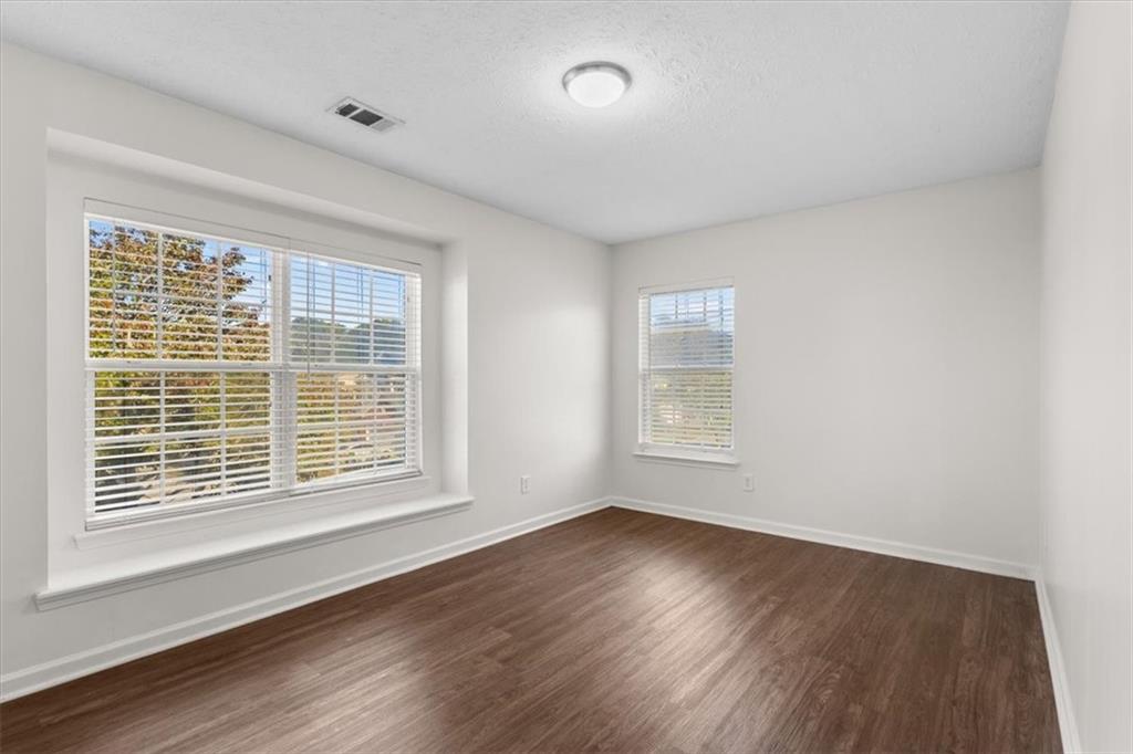2068 White Top Road Southeast Lawrenceville, GA 30045 - Photo 34 of 41 a view of an empty room with wooden floor and a window