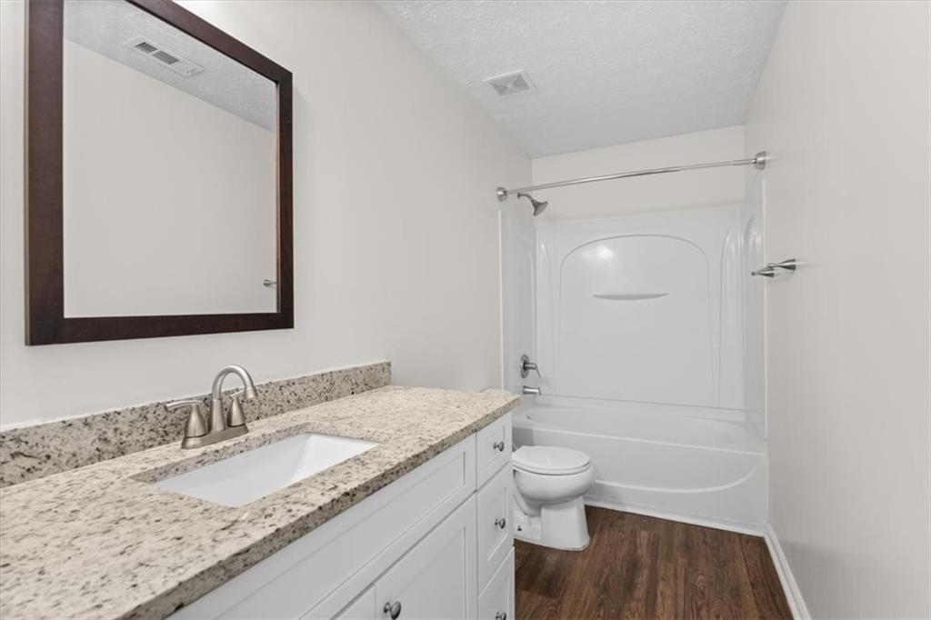 2068 White Top Road Southeast Lawrenceville, GA 30045 - Photo 35 of 41 a bathroom with a granite countertop sink toilet and shower