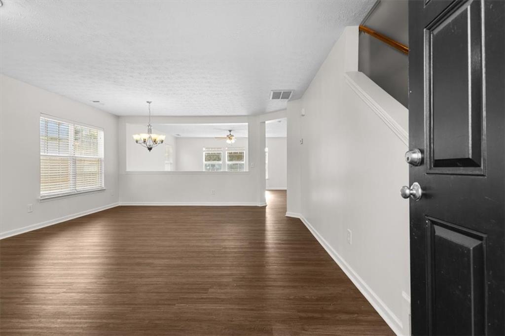 2068 White Top Road Southeast Lawrenceville, GA 30045 - Photo 4 of 41 a view of an empty room with wooden floor and a window