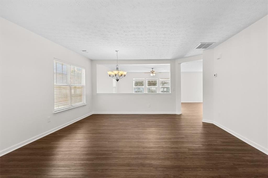 2068 White Top Road Southeast Lawrenceville, GA 30045 - Photo 5 of 41 a view of empty room with wooden floor and fan